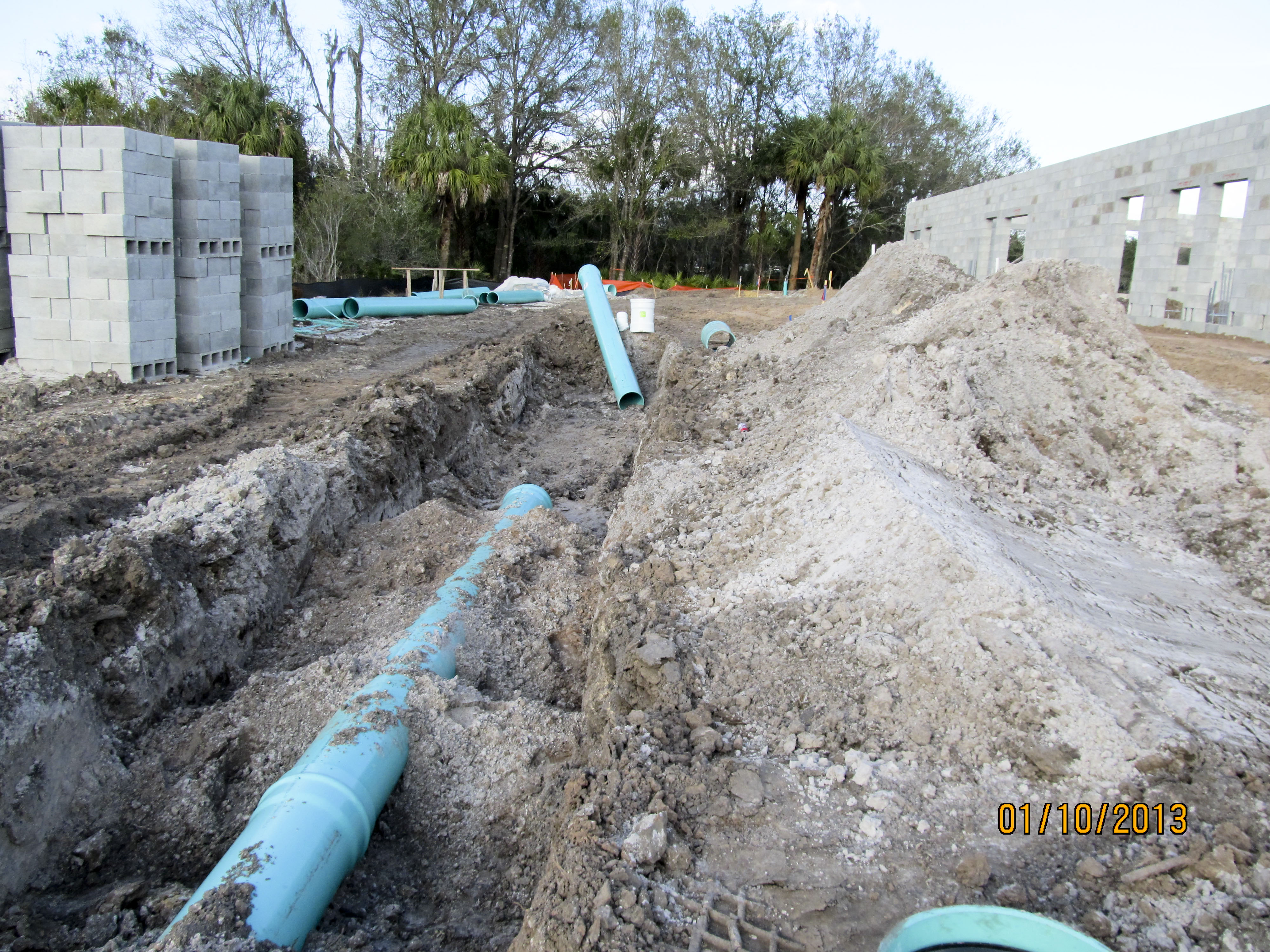 Utility pipes are laid in the ditches.