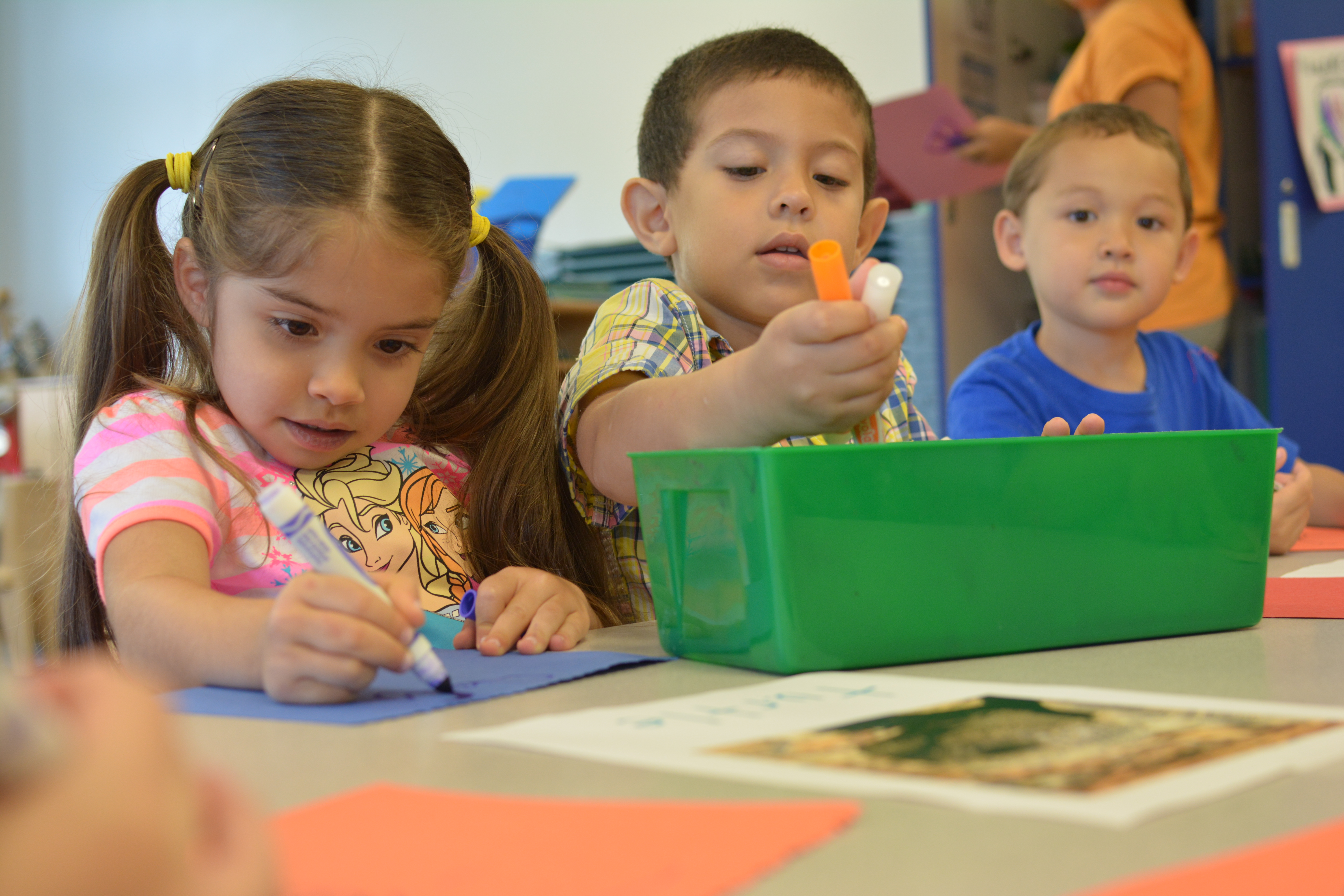 three children drawing