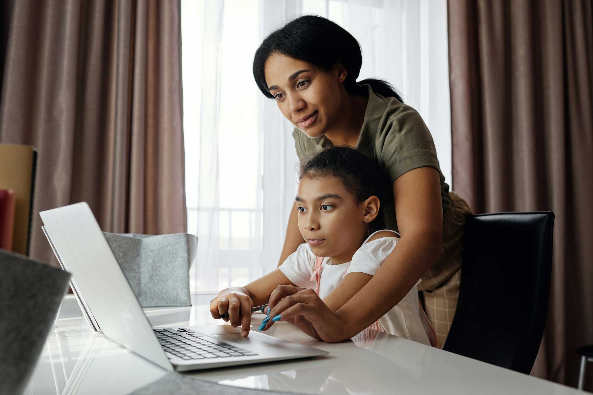 parent helping child virtual learning coach