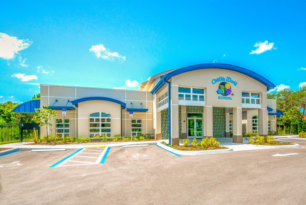 Front view of Creative World School at Naples, featuring the modern building design and vibrant landscaping.