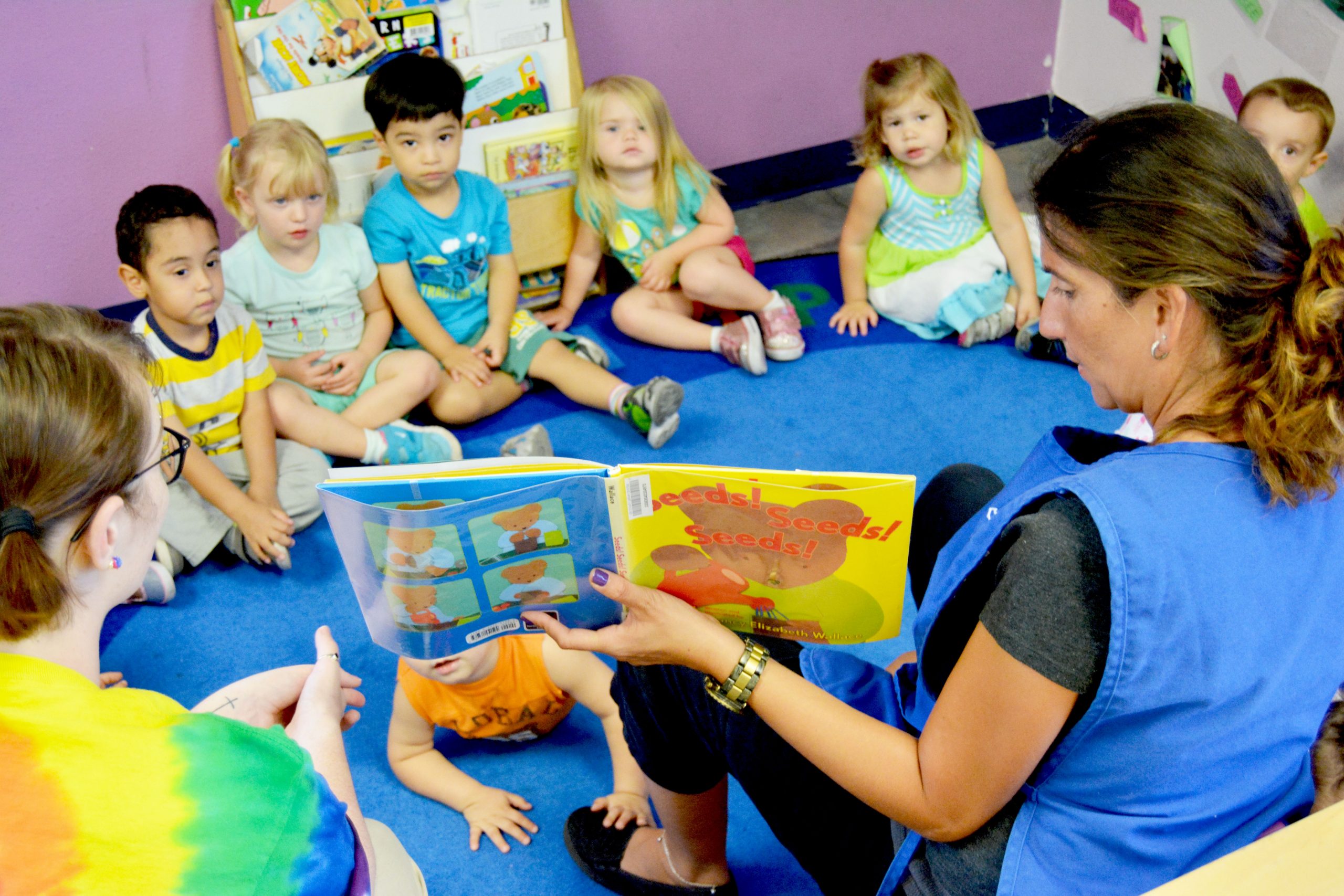 Teacher engaging children during listening and reading time