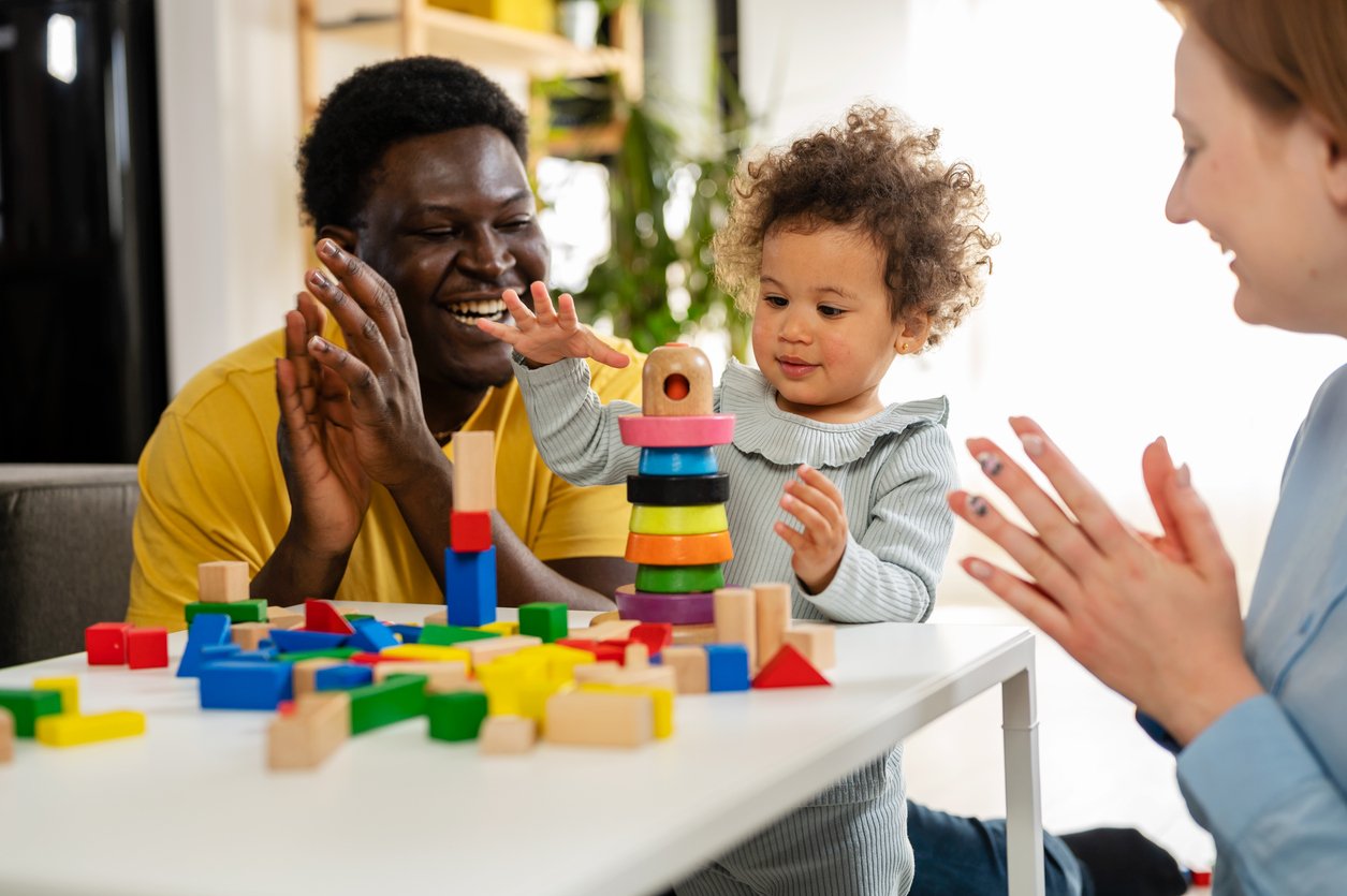 Toddler playing independently with building blocks