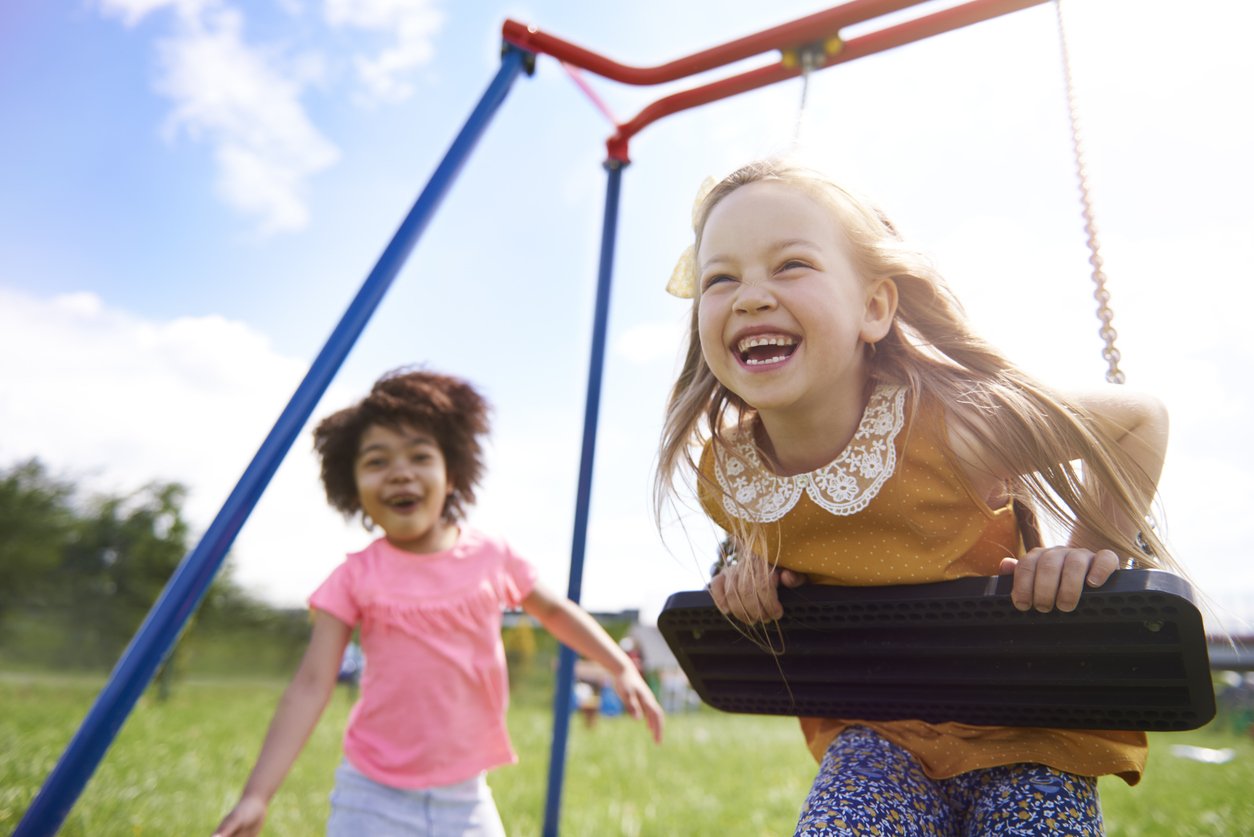 Preschooler playing at Oakstead covered playground