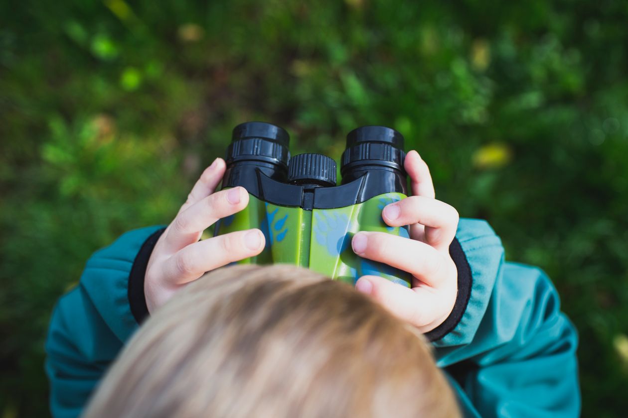 Overhead shot of a kid holding binoculars