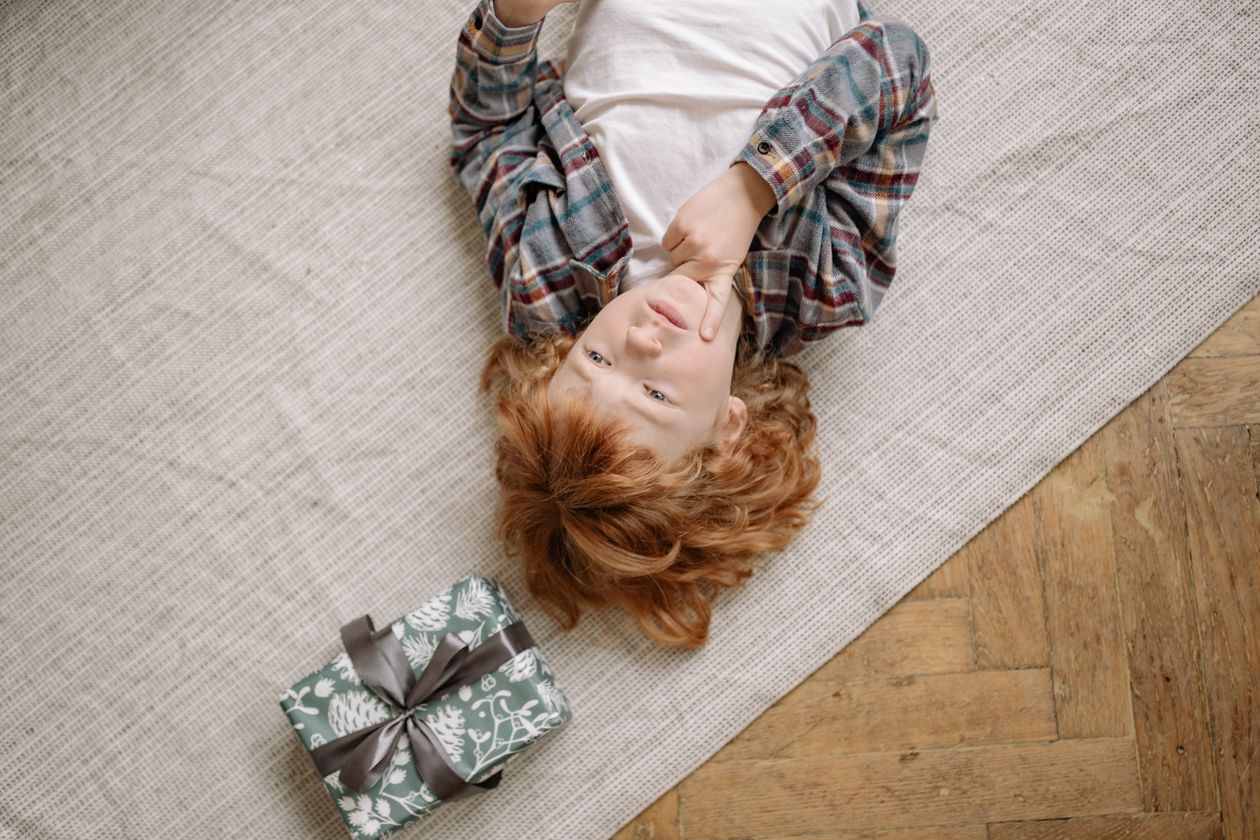Boy lying on the floor while thinking