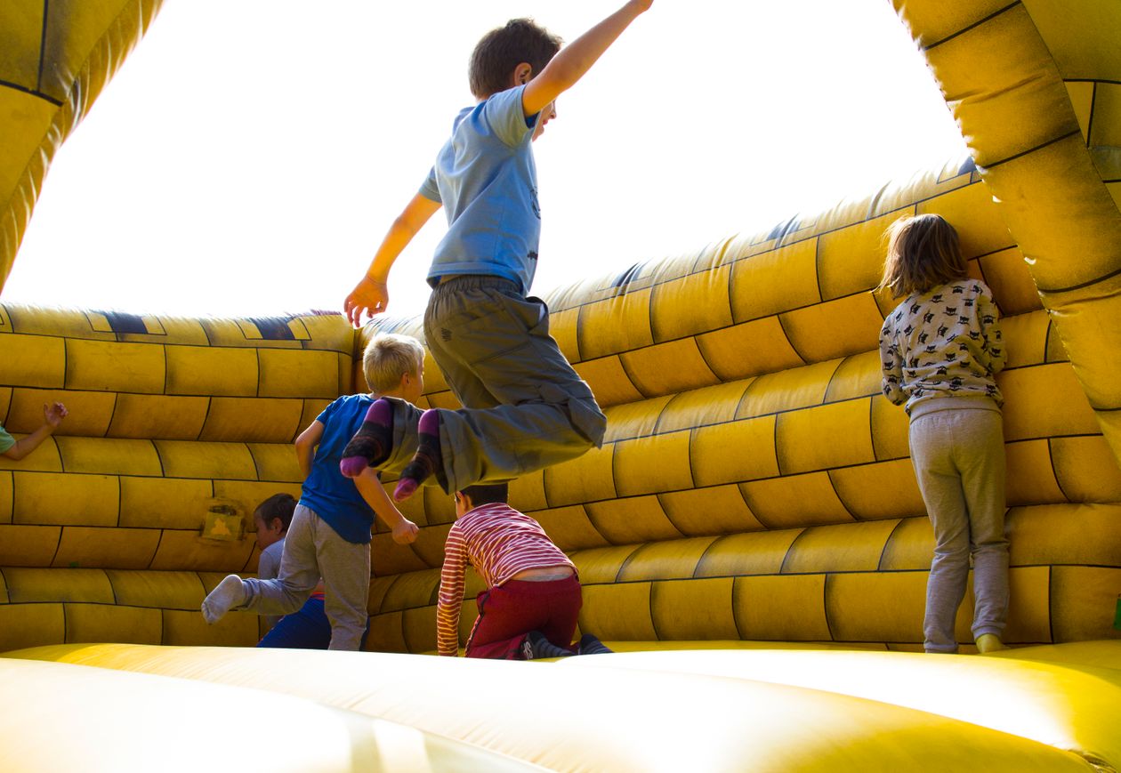 Children playing on an inflatable castle