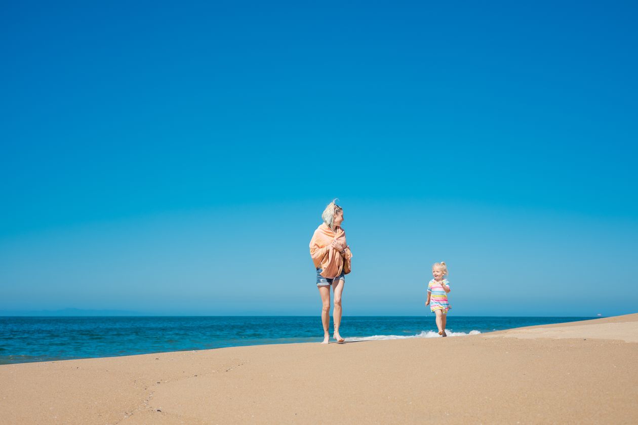 A woman and her daughter at the beach