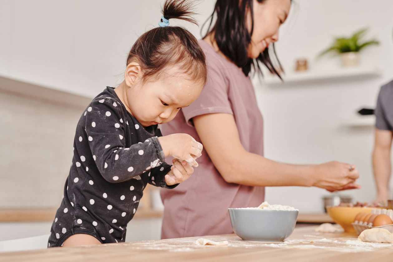 Photo of a child with flour on her hands