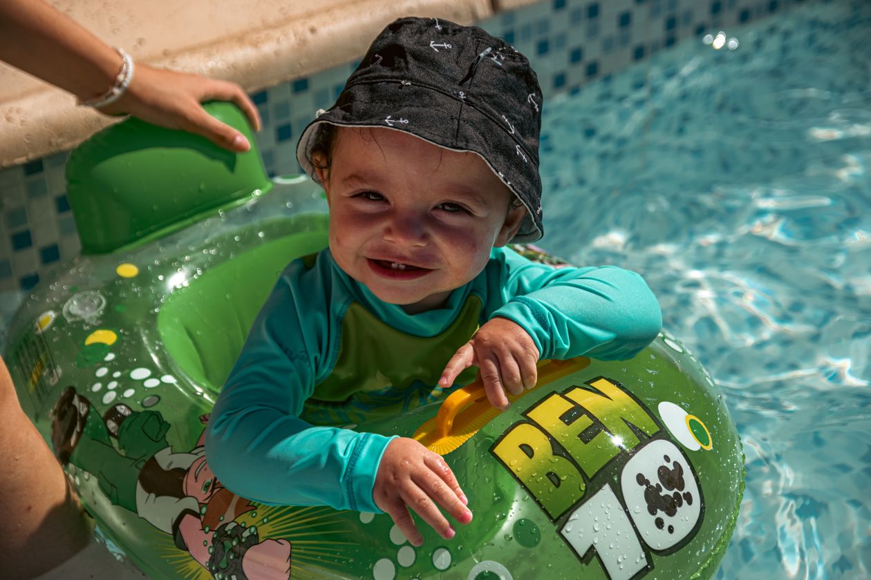 Toddler enjoys pool fun in green swim ring