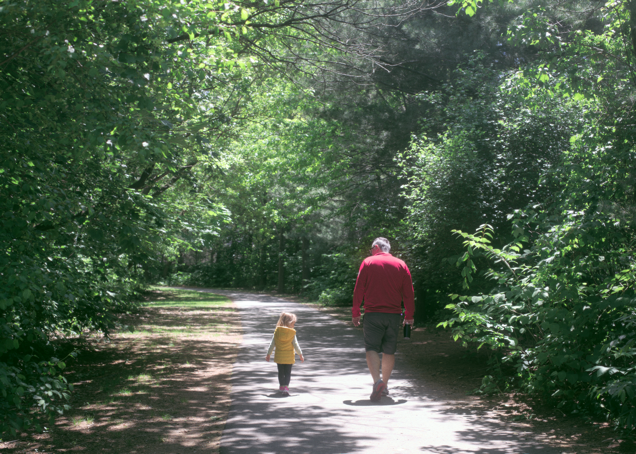 Father and child strolling in Waltham Park
