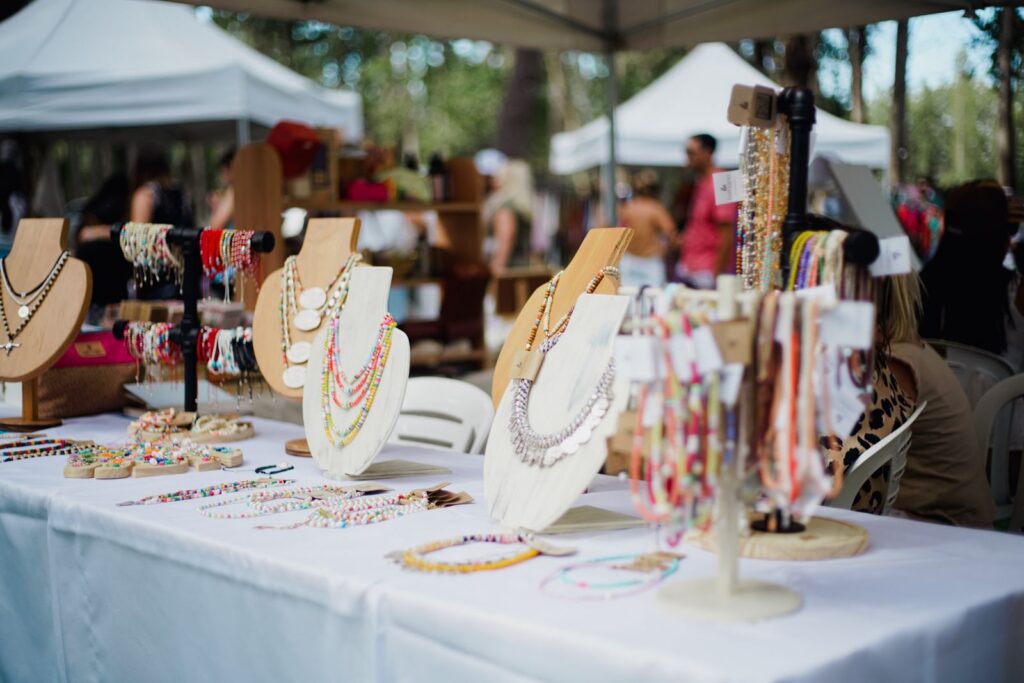 Handmade beaded jewelry on display at an outdoor craft fair booth like Great Day in the Country in Oviedo