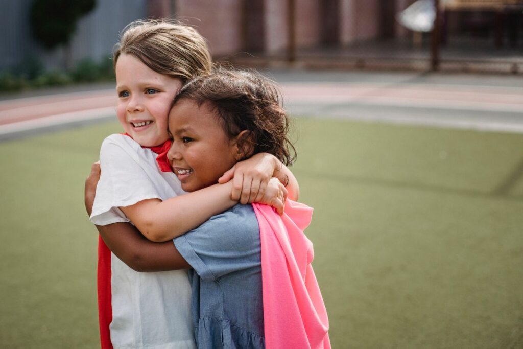 Two young girls hugging each other