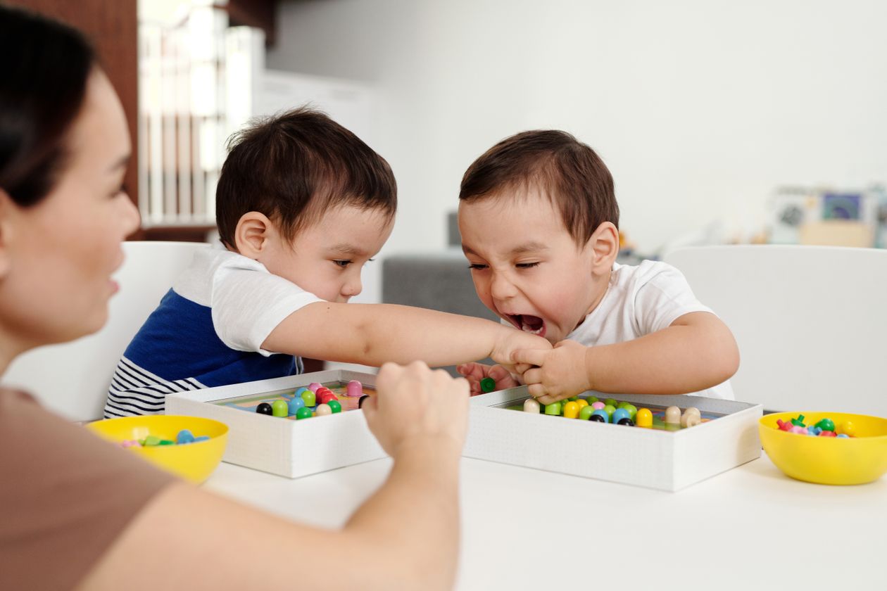 One little boy trying to bite another while playing